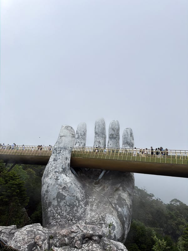 Morning tourists visit Vietnam's famous Golden Bridge attraction