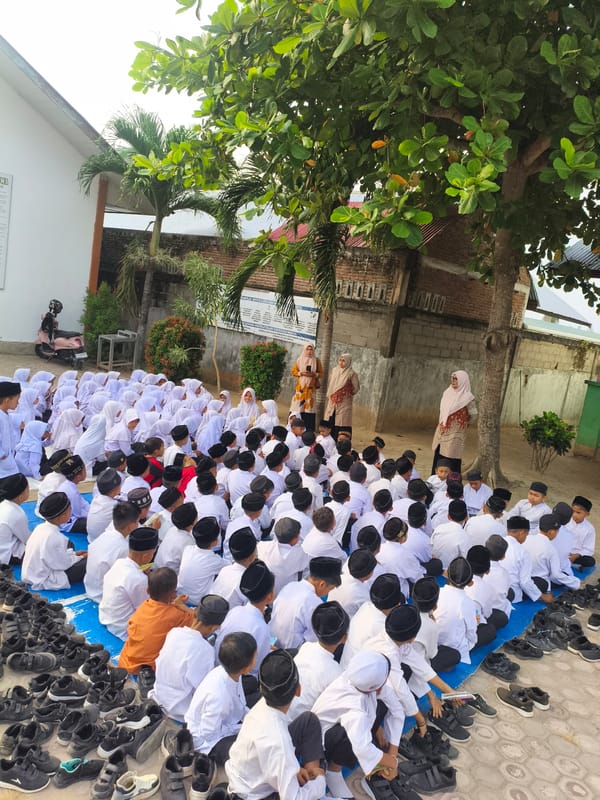 Children in Islamic dress gather for outdoor religious session in Indonesia