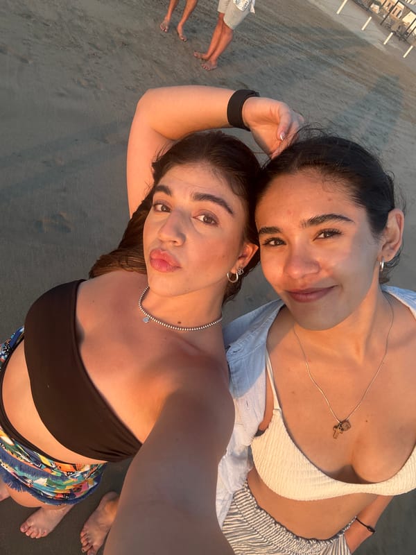 Women take beach selfie during Acapulco sunset gathering