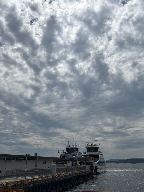 Cloudy morning at Aker Brygge — ferries, streets, and Oslo life