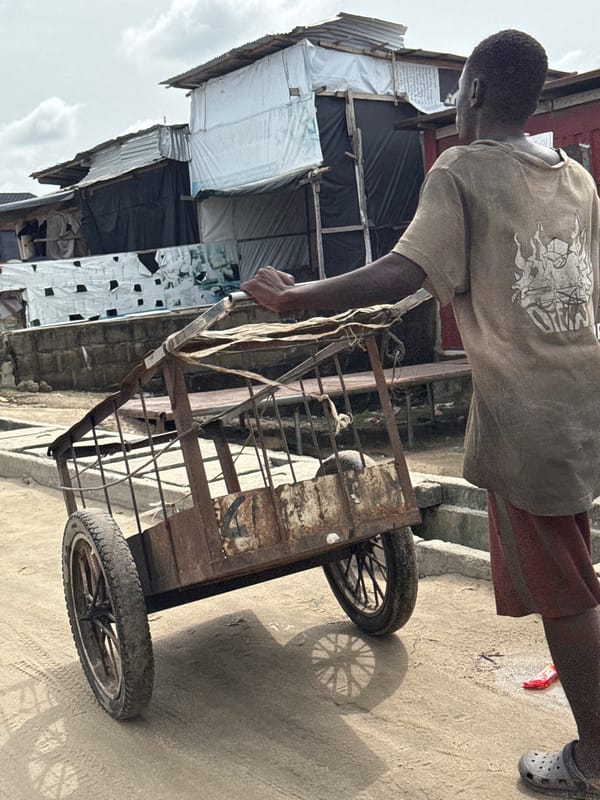 People carry loads through wet streets in Nigeria cities