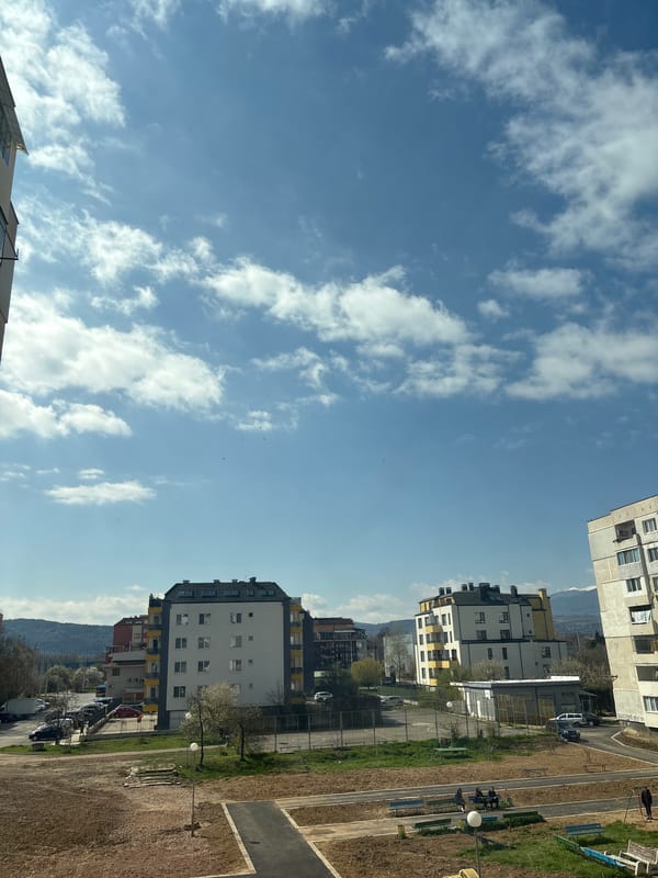 Sofia cityscape observed under bright partly cloudy morning sky
