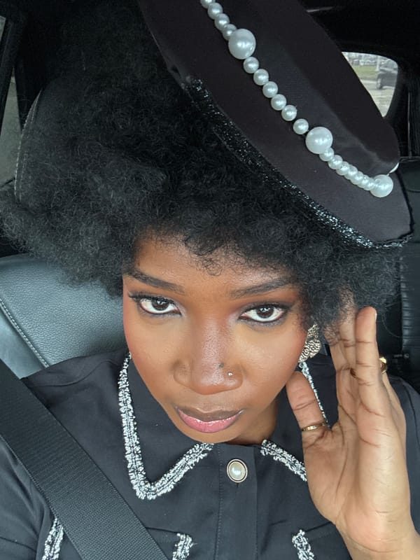 Woman in pearled black outfit spotted in car across Nigeria