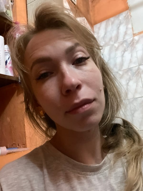 Woman observed in dim indoor setting in Perm