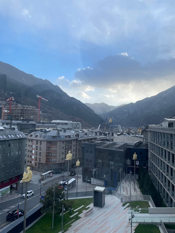 Tourist captures Andorra la Vella cityscape and street art