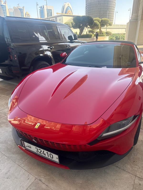 Red Ferrari spotted parked with SUV in Lusail