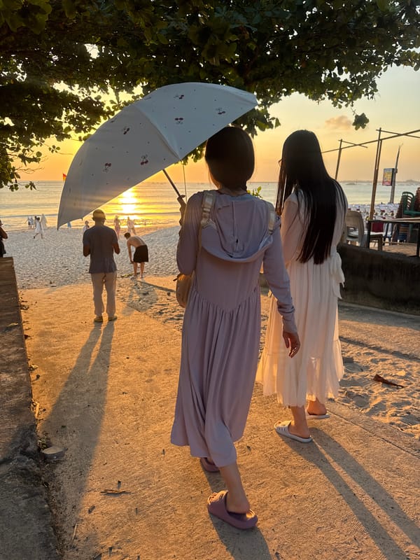 Kuta Beach at golden hour, planes landing and crowds watching the sunset