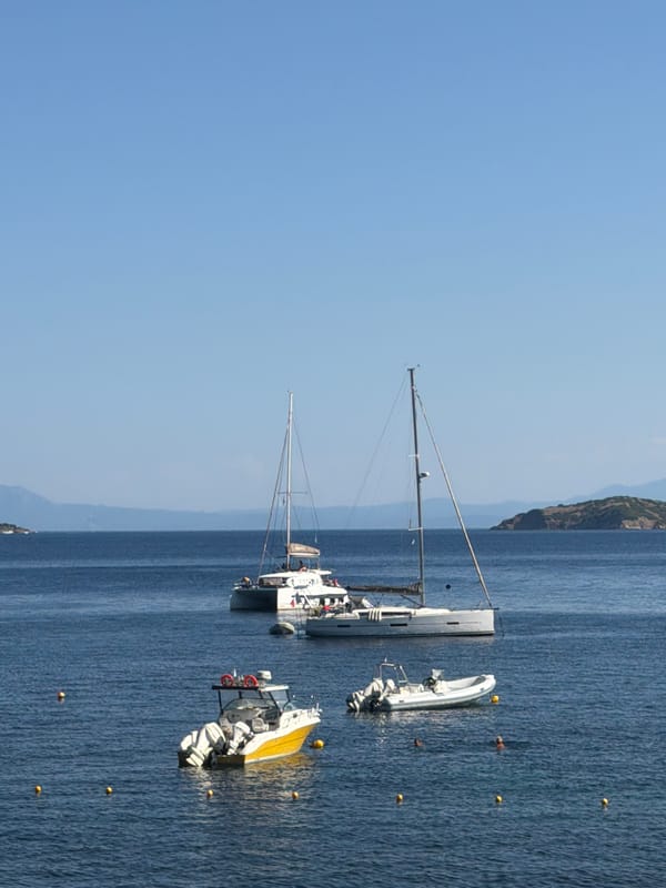 Boats anchored and beach packed on a Skiathos afternoon