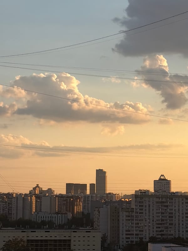 Moscow residential neighborhoods glow under a late-afternoon sunset.