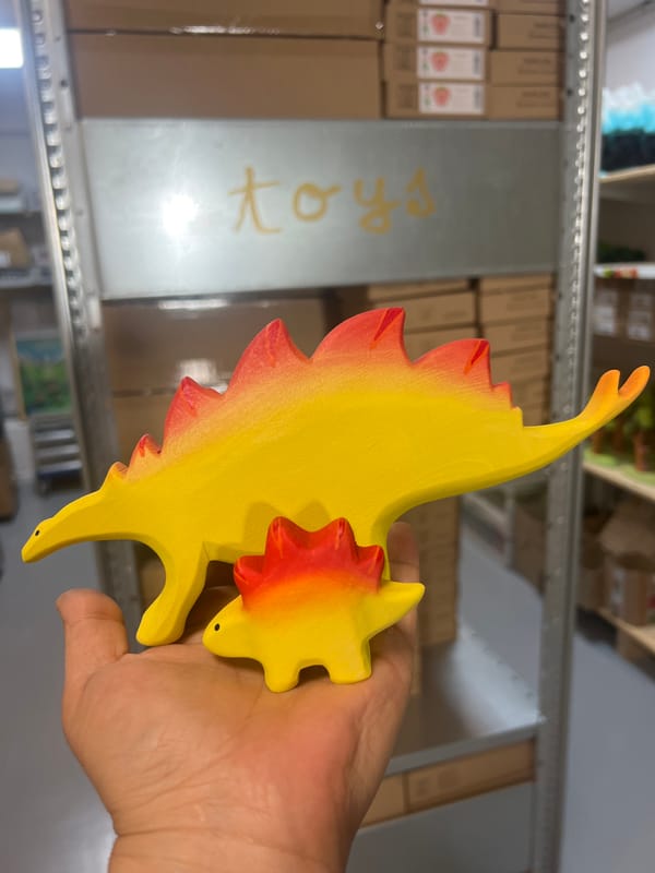 Browsing colorful handmade wooden toys and crafts in a shop