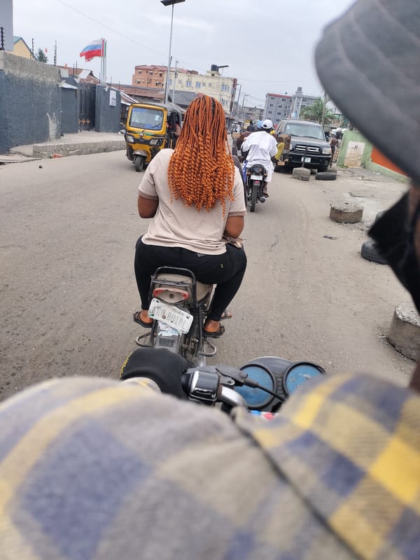 Street activity observed in Alaiyabiagba featuring motorcycle passenger, van
