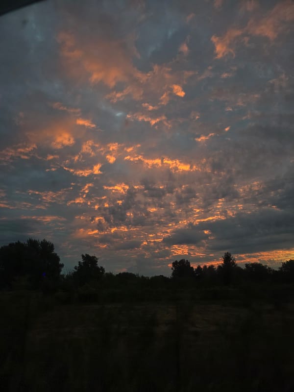 Vivid sunset sky caught from a moving car and roadside