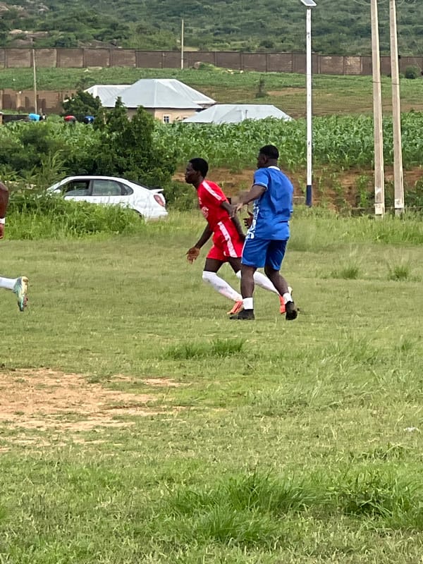 Soccer practice and match play on a field in Jos, Nigeria