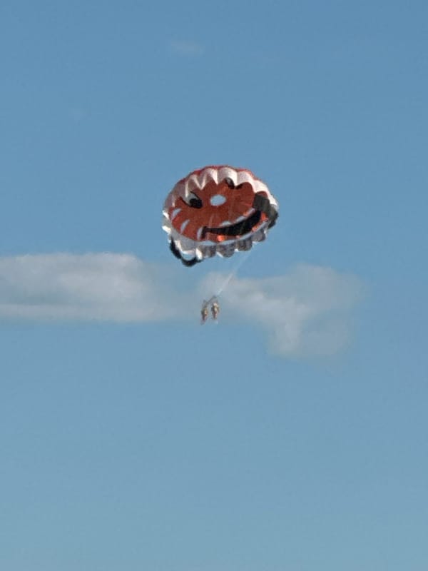 Parasailing and beach volleyball on a sunny Boreti afternoon