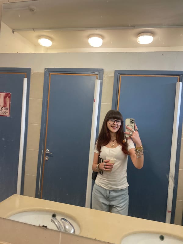 Woman takes morning selfies amid spring blossoms in Raanana