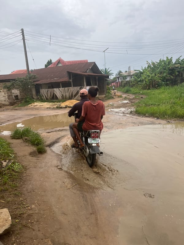 Motorcyclists navigate flooded roads in Ikot Ekpene, Nigeria