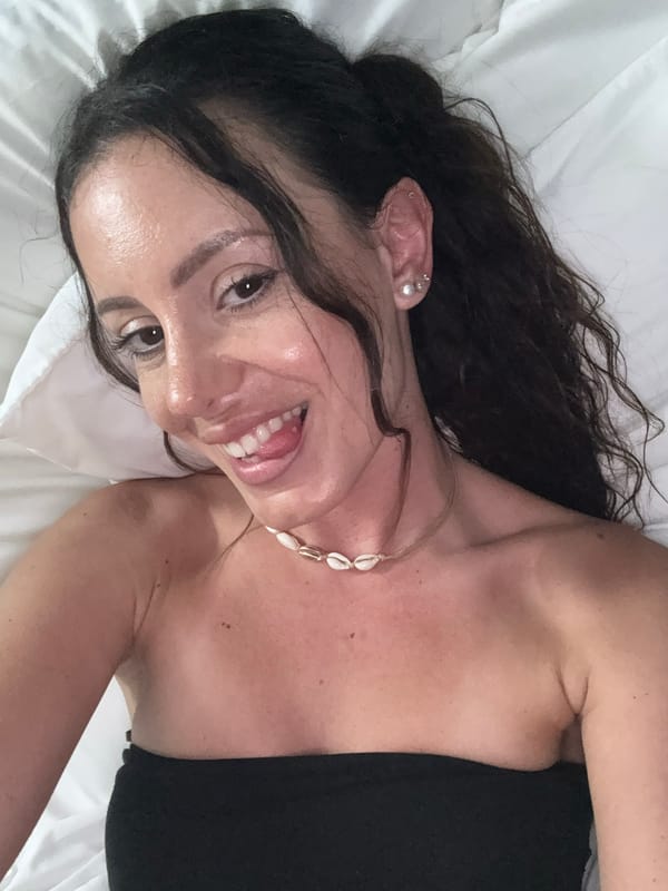 Woman in black top rests on white surface in Sarasota