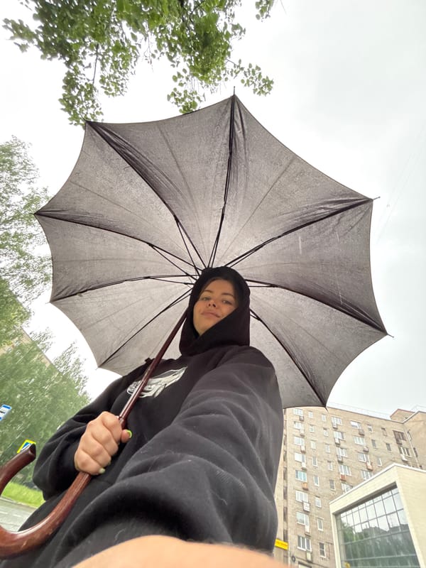 Woman with umbrella photographed during early morning rain in Izhevsk