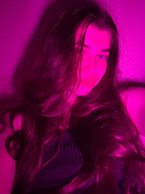 Woman poses for pink-lit photo session in Russia