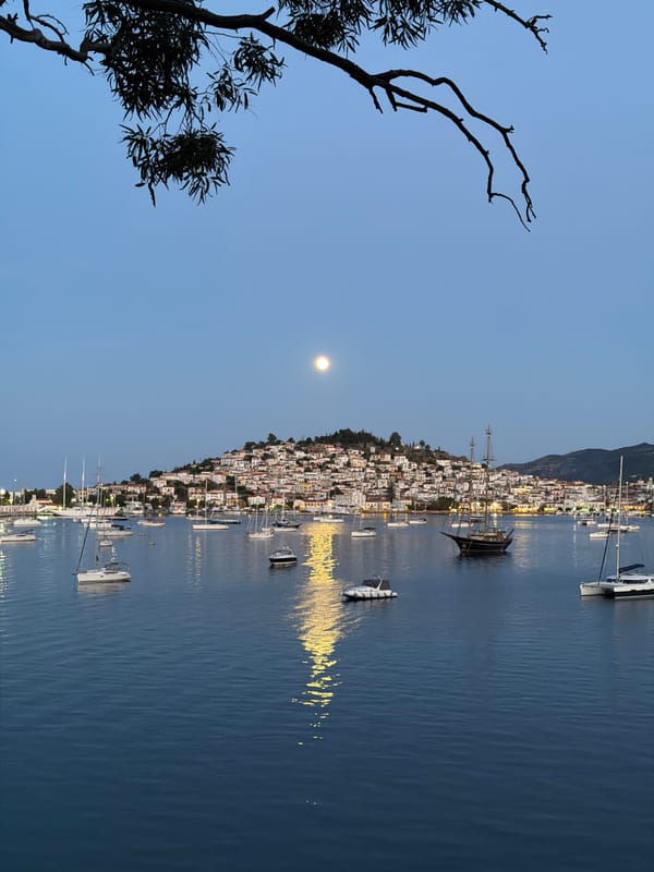 Evening scenes captured across Poros, Greece include moonrise and harbor