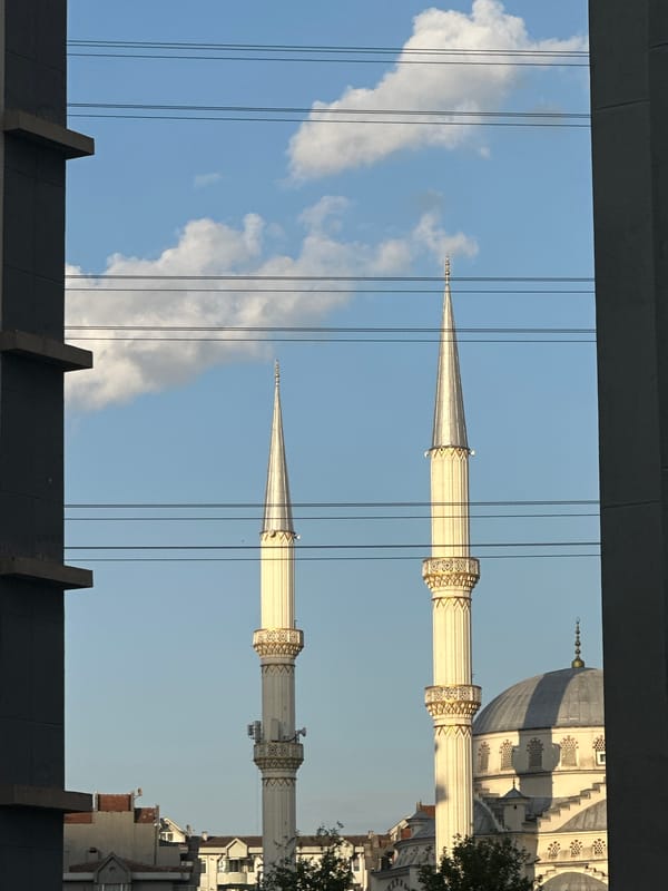 Mosque minarets framed by modern buildings in Esenyurt, Turkey