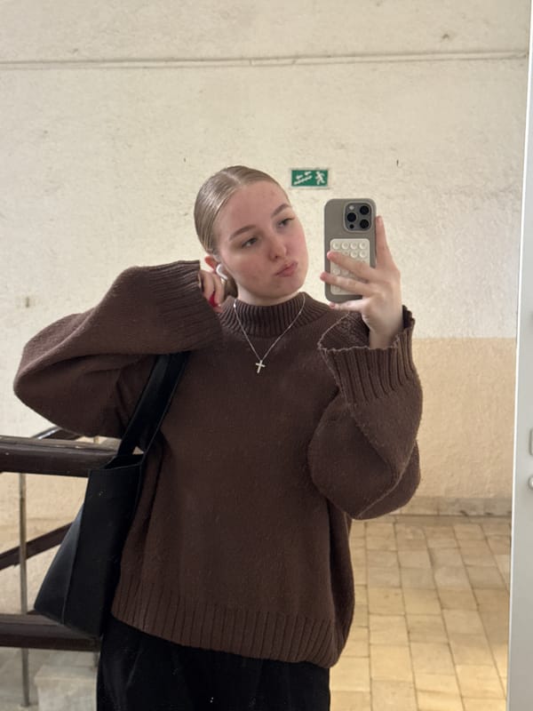 Woman takes selfie, walks hallway in Perm building
