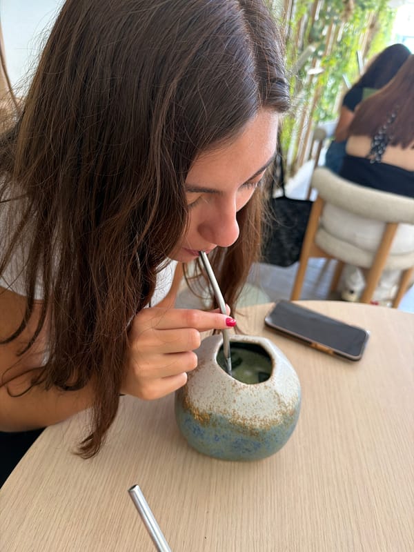 Woman enjoys traditional mate and matcha drinks at Puebla cafe