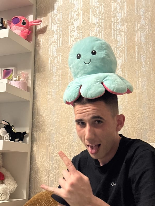 Young man poses playfully indoors in Karlovo residence