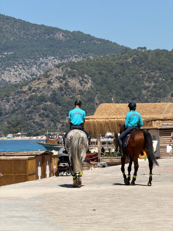 Morning beach life and mounted police patrols in Fethiye