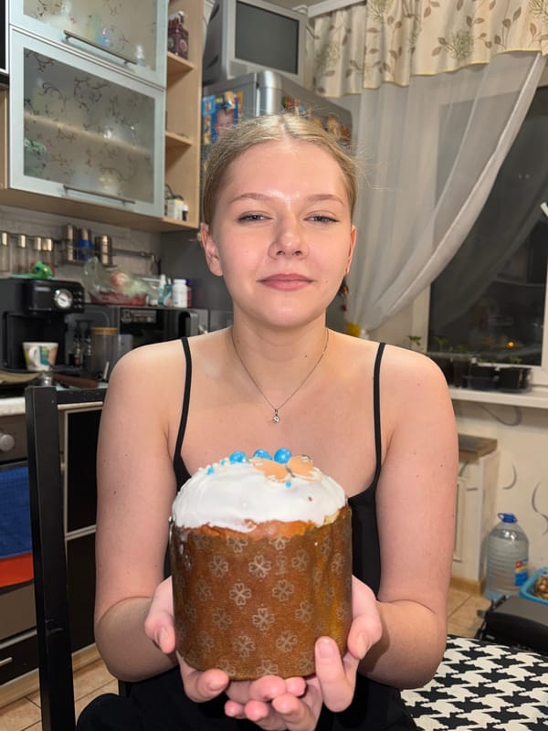 Woman celebrates Easter with traditional cake and pug in Perm