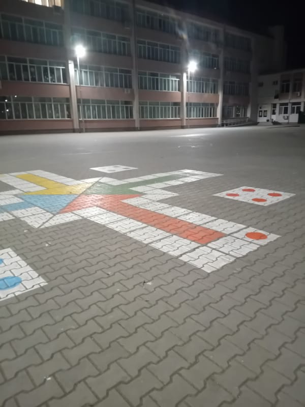 Evening documentation of community recreational area with games and artwork