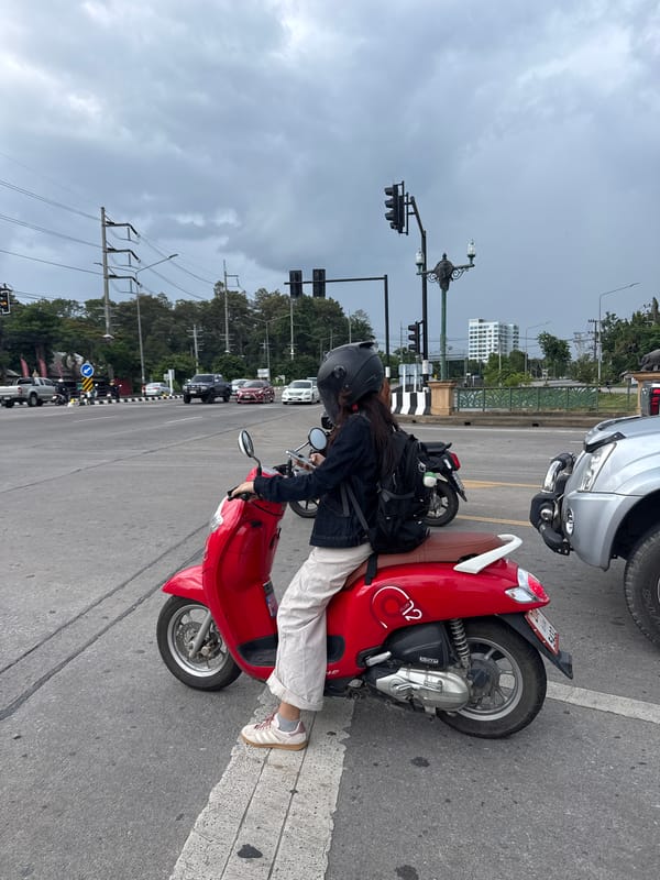 Red scooter paused at a traffic light in Chang Phueak