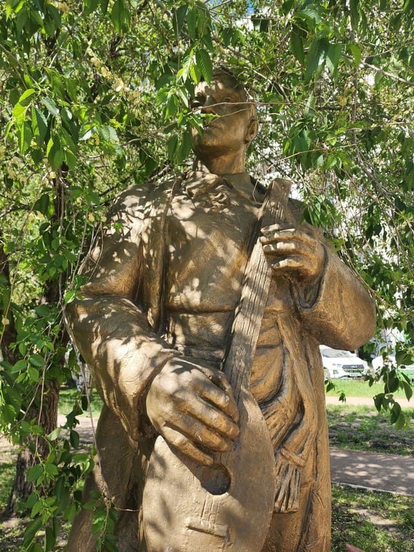 Bronze musician statue documented in Kazan park setting