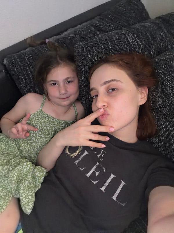 Mother and daughter share quiet afternoon moment on Strasbourg couch