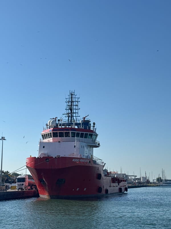 Ship Asso Ventotto docked at Ravenna port with trucks