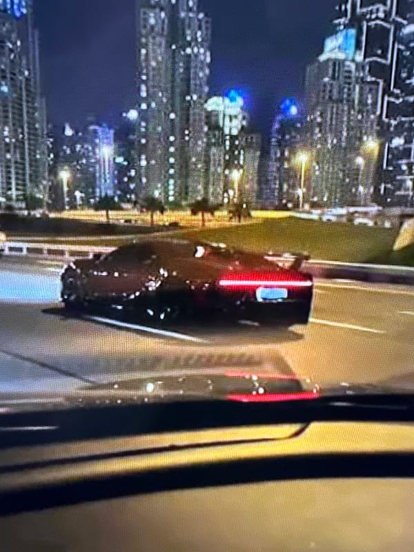 Unrelated snapshots: cityscape, beach sunset, luxury car, handgun