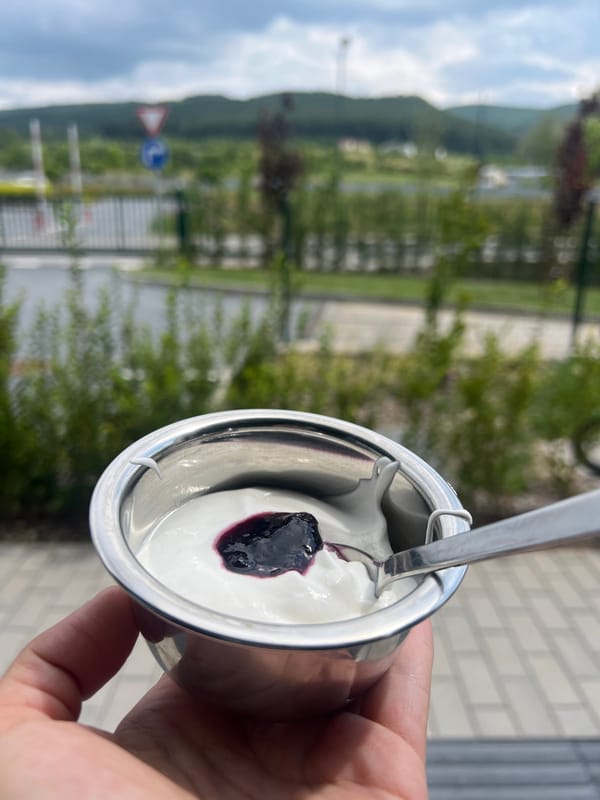 Yogurt with berry jam, mid-spoon in Lozen, Bulgaria