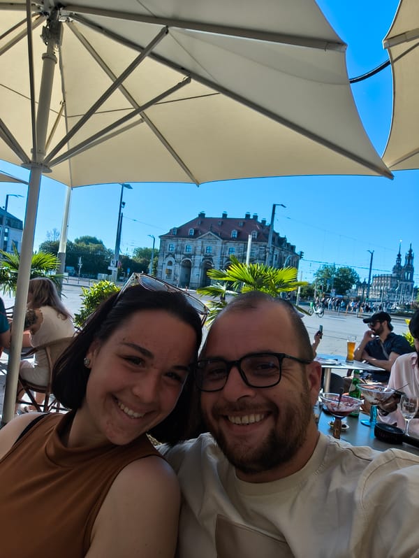 Couple dines with dog at Dresden cafe near Frauenkirche