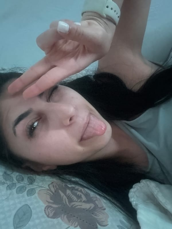 Person makes playful gestures on bed in Bulgaria