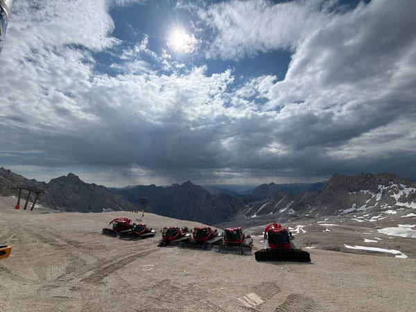 Summer morning at the Zugspitze: snow groomers, rocky terrain, and alpine views