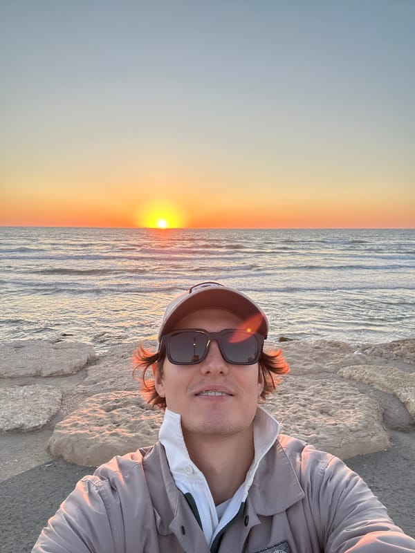 Man takes selfie at Tel Aviv coast during golden hour