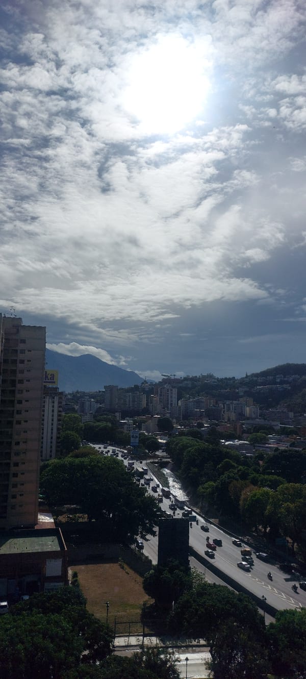 Daylight panoramic views captured of Caracas cityscape under bright skies