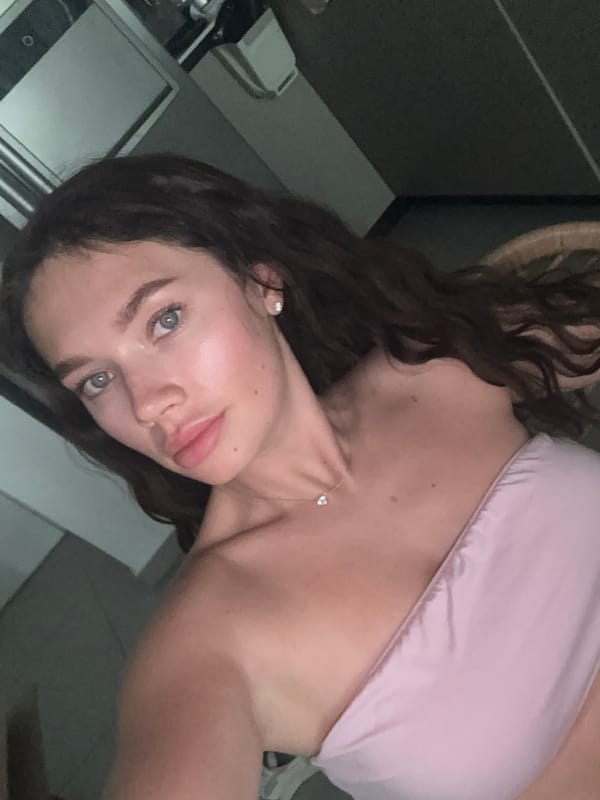 Woman takes selfie in Givatayim wearing pink top