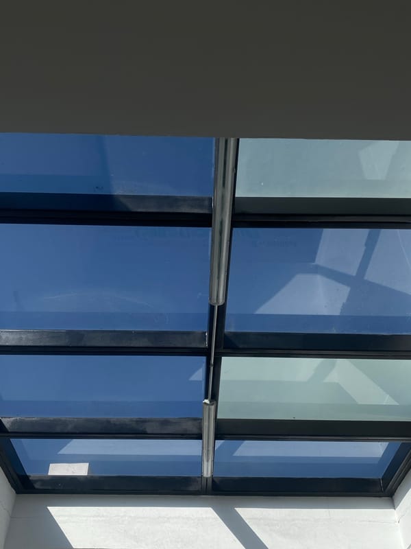 Building windows reflect clear blue sky in architectural photograph