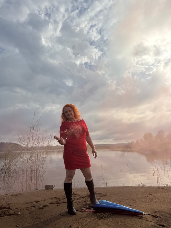 Woman conducts colorful smoke photo session near Russian lake