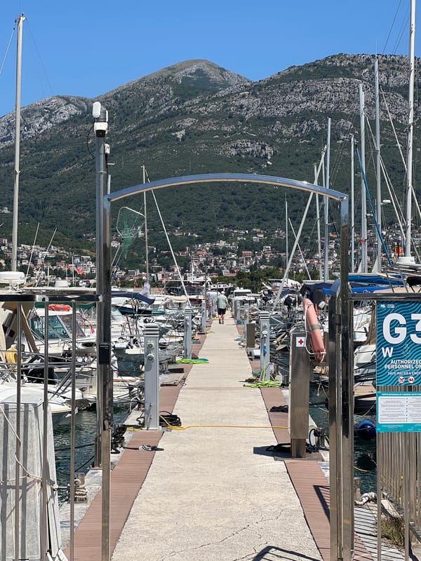 Colorful vehicles and boats at Bar Marina, Montenegro