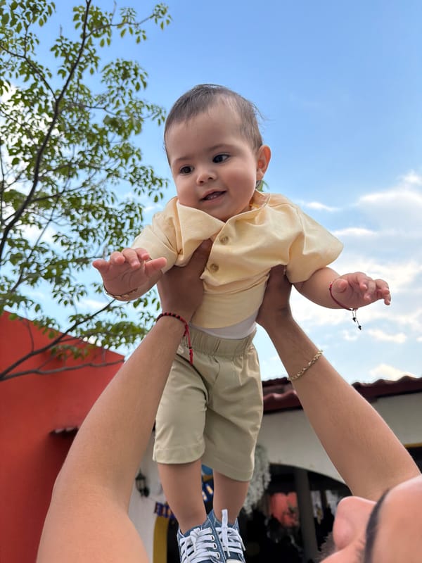 Baby held skyward captured in photograph in Cuautla, Mexico