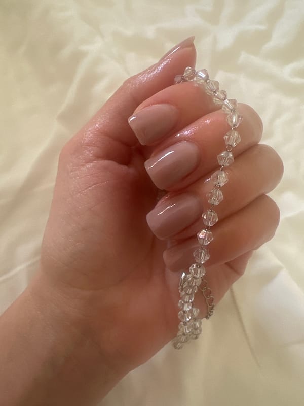 Person shows crystal beaded jewelry collection in Petah Tikva