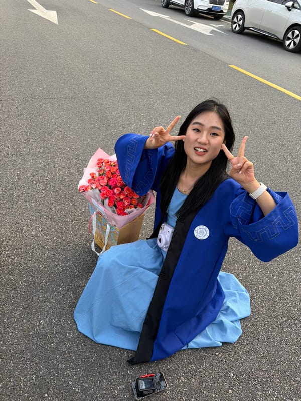 Woman in traditional dress sits on street in Jiangning