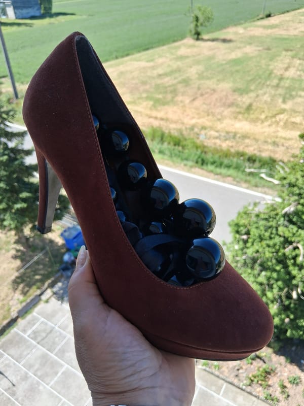 Artistic shoe installation documented in Colorno, Italy